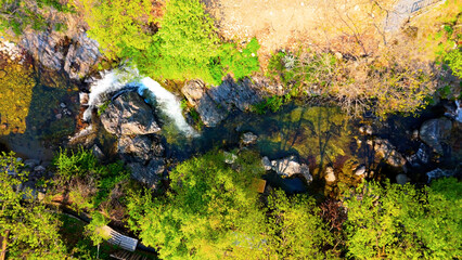 A view of a valley in early summer colored with green light. A beautiful natural view of Sillim, Gangwon Province, Korea's attraction, taken with a drone in the sky. A trip to Gangwon Province