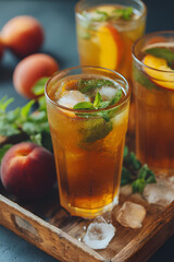 Refreshing peach iced tea served with fresh mint leaves in a rustic setting
