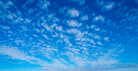 Sky view. Beautiful sunny sky. Background with clouds on blue sky. Clouds on blue sky. Sun shining...