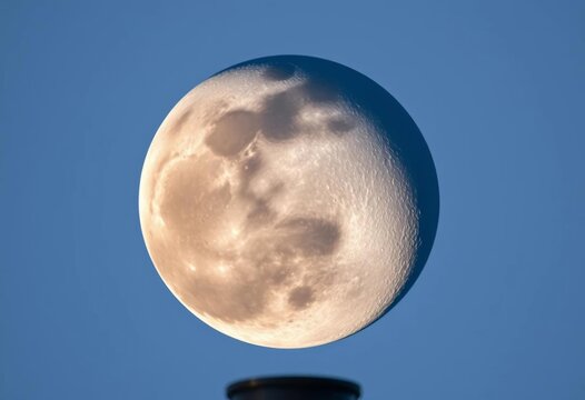 Telescopic view of a waxing gibbous moon, craters and surface detail visible, full moon, craters