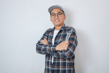 Repairman mechanic, Asian young handyman holding tools and wearing isolated on background.