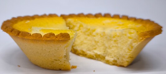 Egg tarts that are crispy on the outside and soft on the inside. Egg tarts that have a rich and creamy egg aroma. Egg tarts on white background.