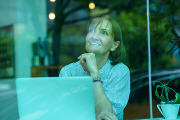 senior women using laptop working, senior owner with laptop business finance
