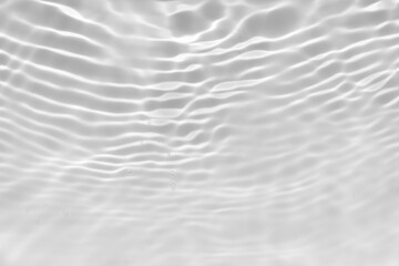 Obraz premium White water with ripples on the surface. Defocus blurred transparent white colored clear calm water surface texture with splashes and bubbles. Water waves with shining pattern texture background.