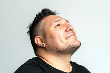 Fototapeta premium Classy men's short spike haircut - midlife white man with black hair. Pure white solid background. A sophisticated male posing with grace. Artwork of style for aging men.