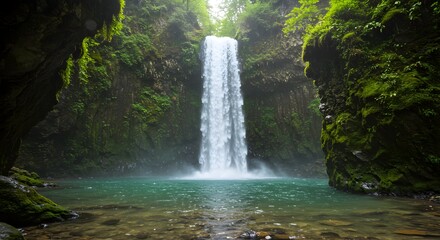 Majestic waterfall cascading into turquoise pool surrounded by lush greenery, creating a scenic natural beauty spot