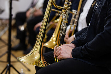 A fragment of a trombone in the hands of a musician in an orchestra