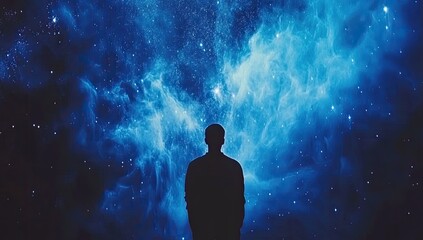Solitary figure silhouetted against a vibrant, blue nebula