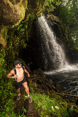 Vertical shot of a male hiker wearing sunglasses walking next to