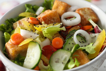 Fried tofu salad in a bowl close-up