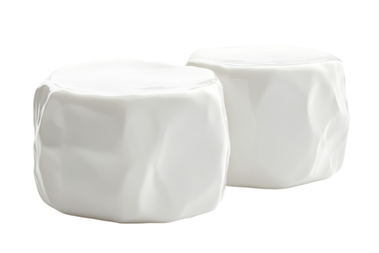 Two white, square, rounded objects, possibly candy or decorations, on black background
