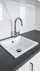 Fototapeta premium A sleek, modern white sink elegantly positioned atop a glossy black countertop, showcasing a striking contrast between the two surfaces.