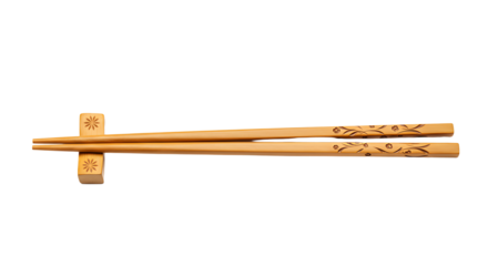 Elegant wooden chopsticks with floral design resting on a chopstick holder