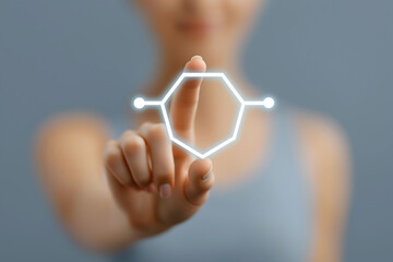 A person touches a virtual hexagonal chemical structure, symbolizing science and technology interaction.