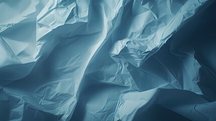 Obraz premium Intricate folds and creases in pale blue paper.