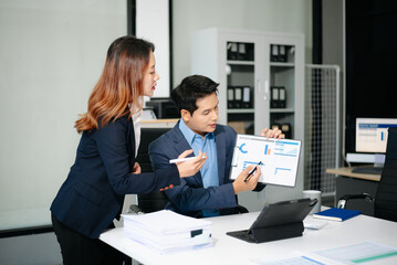 Two busy happy professional business man and woman executive leaders team using laptop working in office