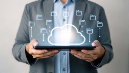 Businessman holding tablet with cloud computing icons representing data storage and technology connectivity in a modern digital environment