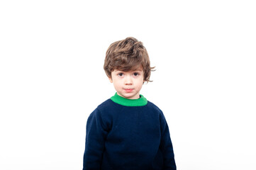 Curly-haired boy poses on white background