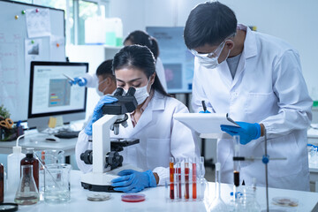 In the laboratory, researchers conduct blood tests and chemical analysis, with doctors taking notes and closely examining samples through the microscope for ongoing research.