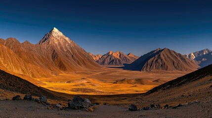 Majestic mountains and valley illuminated by the warm sunset light
