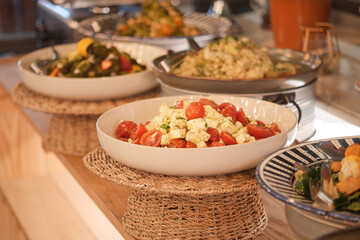 Colorful salad with cherry tomatoes on a table alongside other dishes