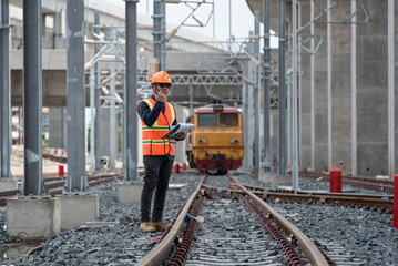 Engineer Inspecting Railway Track During Construction