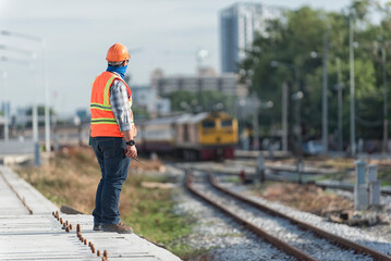 Engineer Inspecting Railway Track During Construction