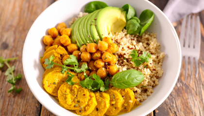 vibrant vegan bowl featuring quinoa, chickpeas, avocado, and fresh greens, beautifully arranged for healthy meal. This dish is not only nutritious but also visually appealing, perfect