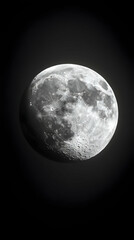 Fototapeta premium Detailed grayscale image of the moon, showcasing its craters and surface texture against a stark black background