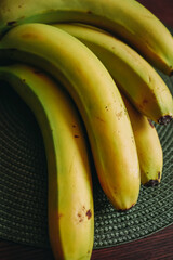 Fresh Ripe Bananas on a Dark Table – Close Up of Tropical Fruit Bunch