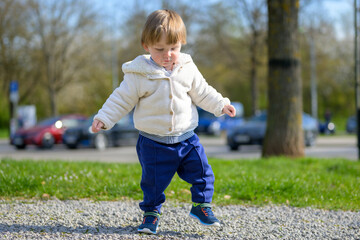 Fototapeta premium Toddler Exploring Outdoors Alone