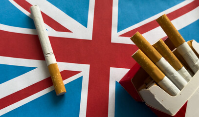 UK flag with cigarette isolated on black background © Angelov