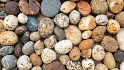 Background of smooth, gray and tan river rocks create a textured surface, suggesting a natural spa or tranquil outdoor setting.