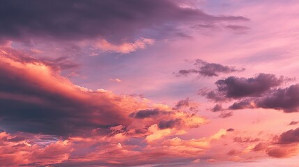 Fototapeta premium Warm Pink and Purple Sunset Sky with Orange Tones and Clouds
