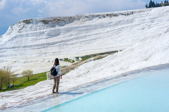Tourist admiring Pamukkale thermal travertines pools in Turkey
