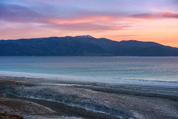 Colorful sunset illuminating Salda lake and distant mountains