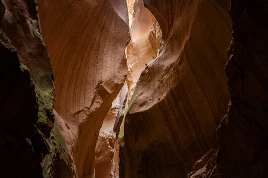 Sunlight piercing through narrow rock formations Avla canyon in