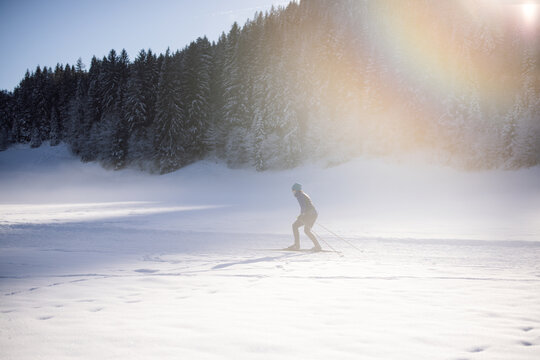 Woman cross-country skiing in snowy Kirchberg in Tyrol
