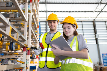 Male and Female worker inspect goods auto parts on shelves in warehouse. logistic import export auto parts. Checklist stock product in storage for logistic.