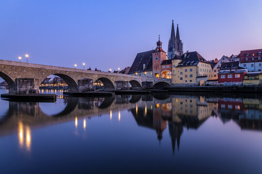 View over the Danube river towards the Regensburg cathedral and the stone bridge in Regensburg, Bavaria, Germany.
