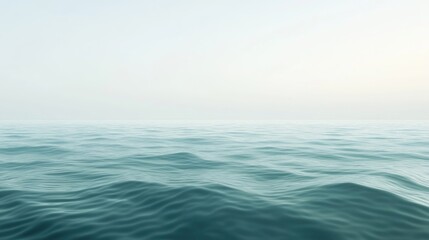 Obraz premium Calm, misty ocean waves at dawn.