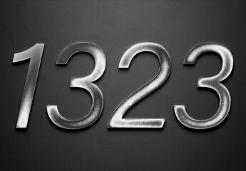 Chrome metal 3D number design of 1323 on grey background.