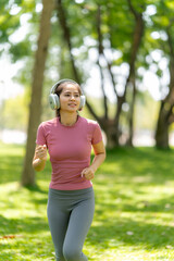 Woman Jogging in Park with Headphones