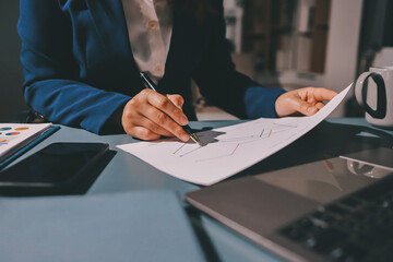 Expert woman asian female people review data number costing managerial account prepare monthly actual cost variance report at tax audit office. ESG sheet budget control ERP process service project.