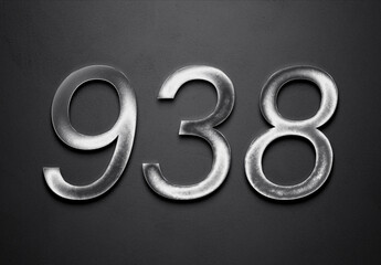 Chrome metal 3D number design of 938 on grey background.
