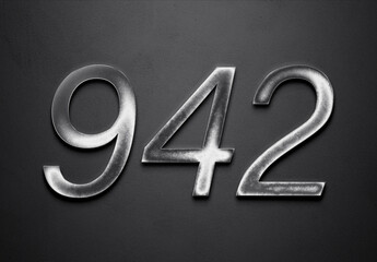 Chrome metal 3D number design of 942 on grey background.