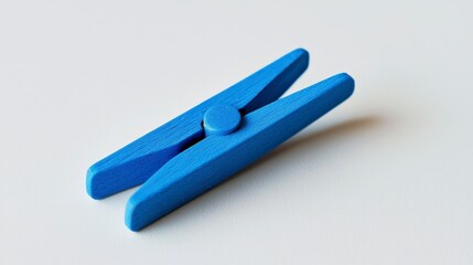 Obraz premium Small Blue Wooden Clothespin on White Background