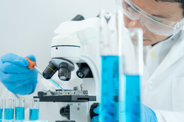Scientist analyze biochemical samples in advanced scientific laboratory. Medical professional use...