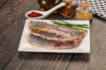 Salted marinated herring fillet with spices