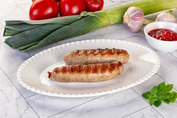 Grilled pork sausages served tomato sauce